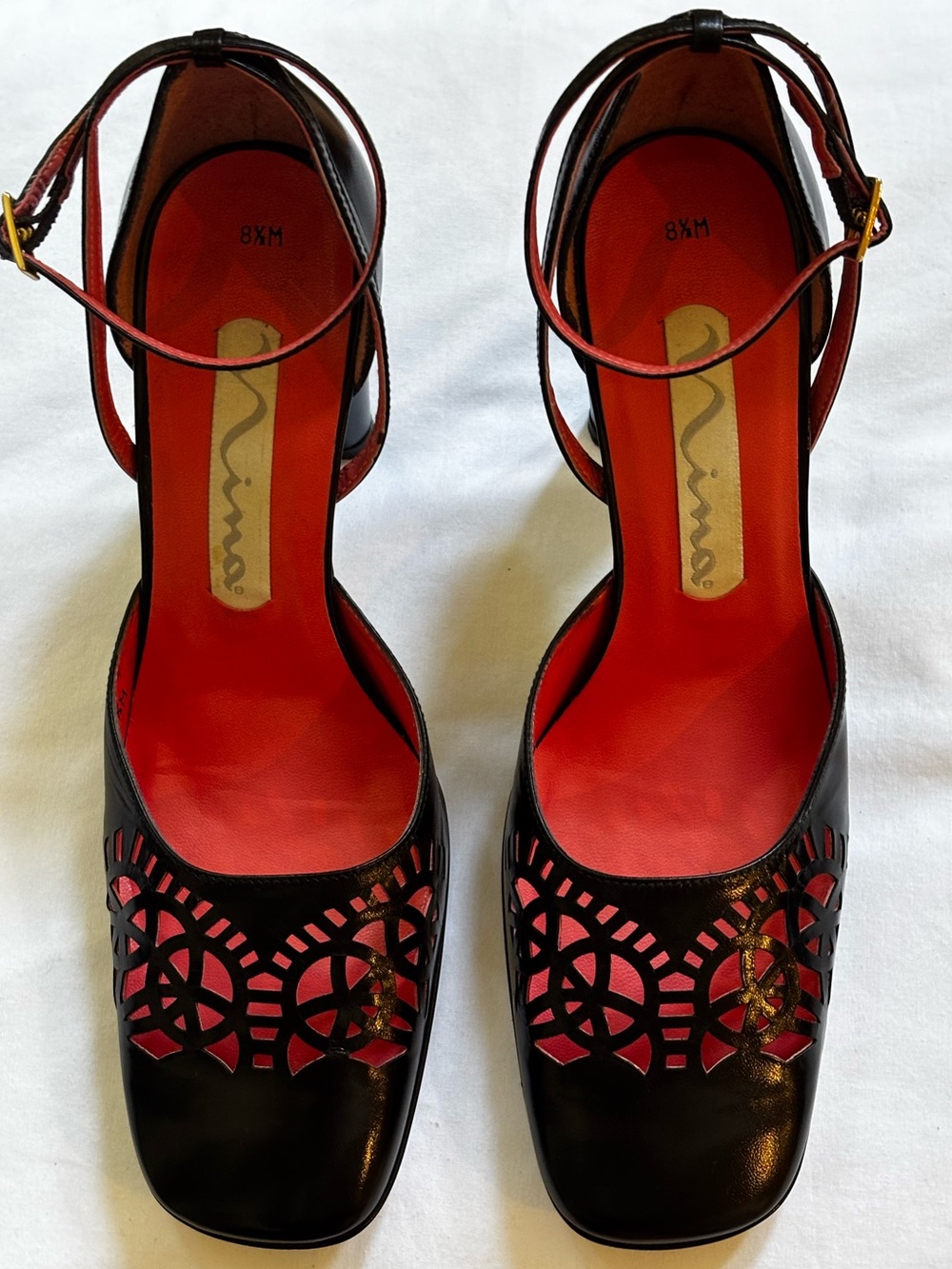 Nina Black Cutout Ankle-Strap Pumps with Coral Lining